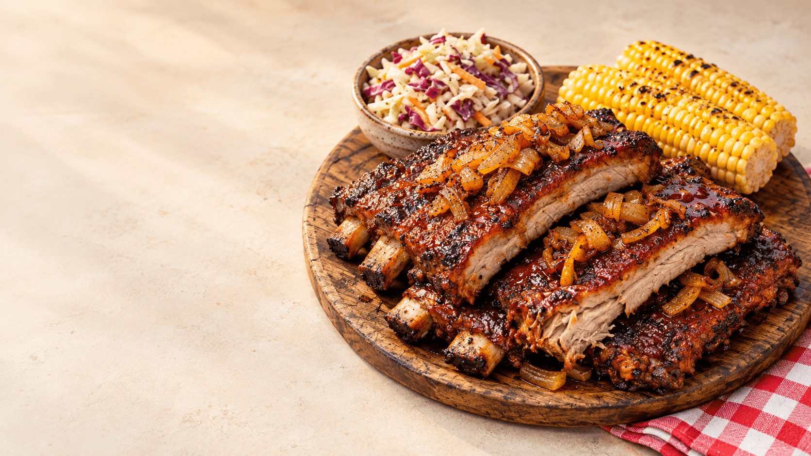 A chef spooning sauce over baked ribs