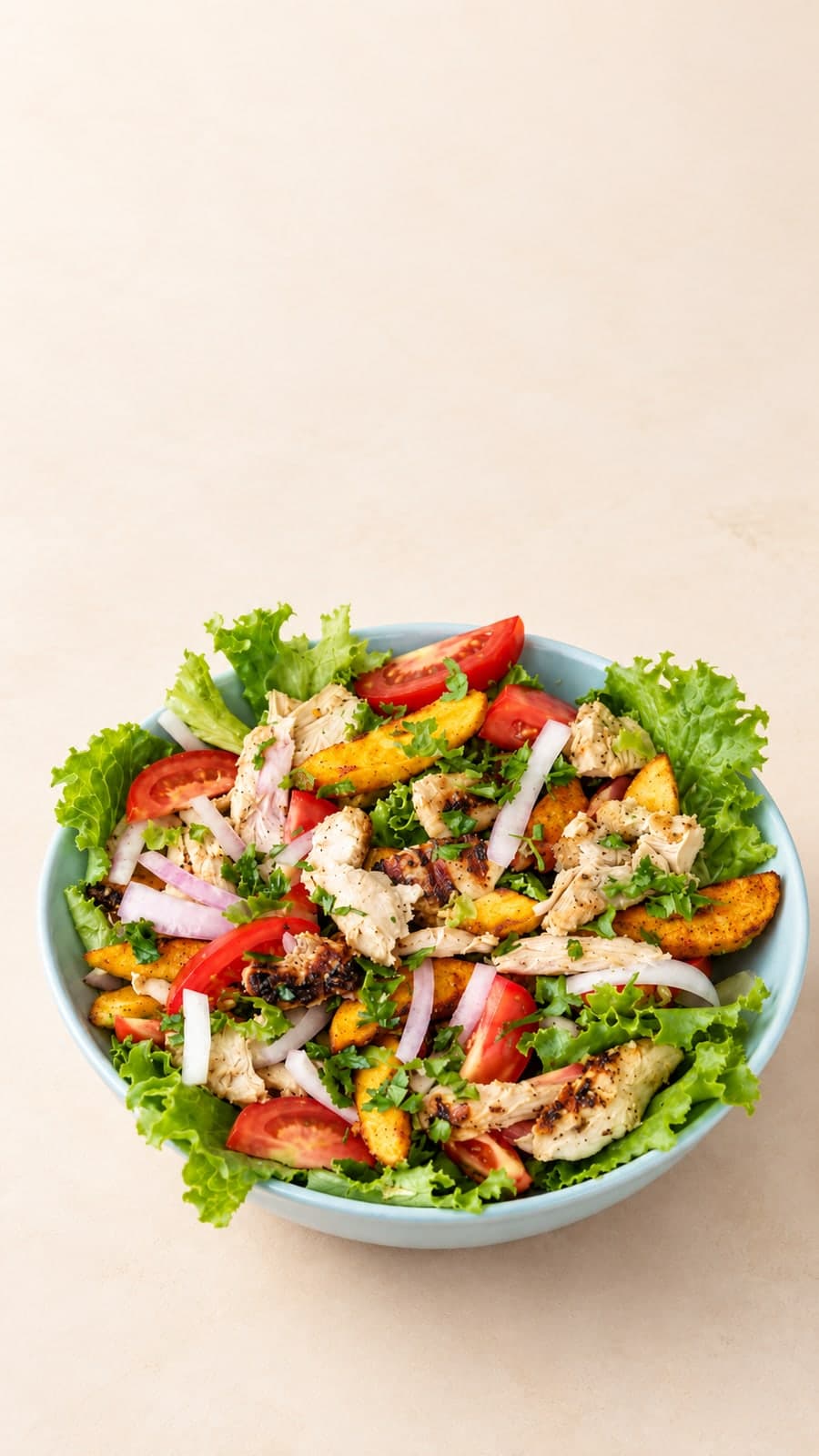 A chef dressing a fresh salad